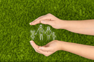 Image of hands protecting a family illustrates one of the main benefits of life insurance.