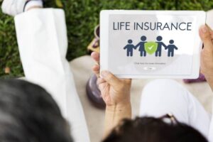 A family using a tablet to choose a beneficiary for their life insurance